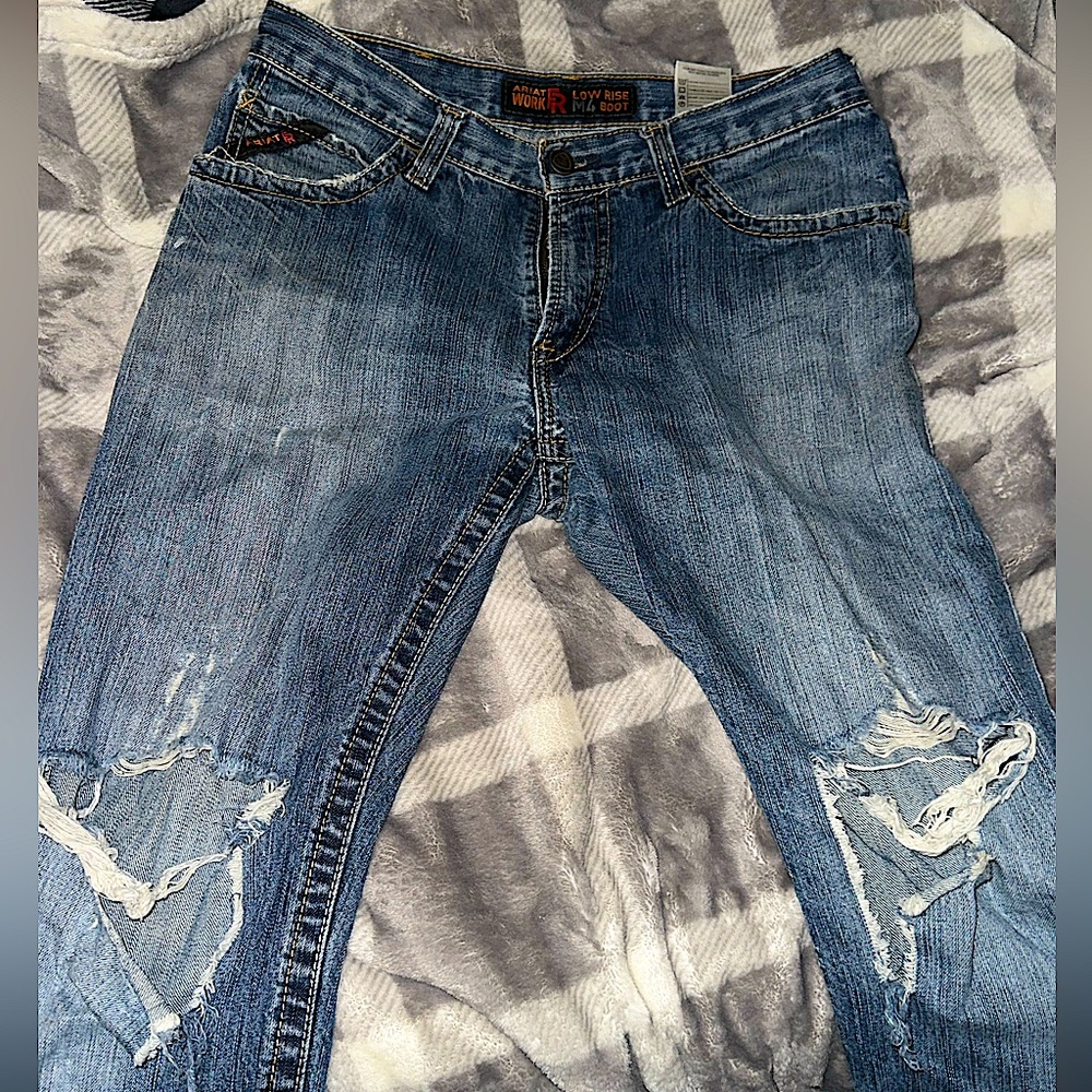 Men’s blue jeans with a rip in each knee